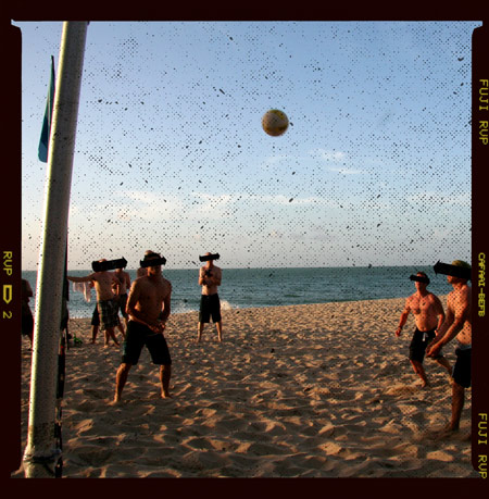 Photo of people playing beach volleyball badly