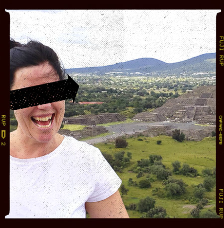 Woman smiling with pyramids in the background